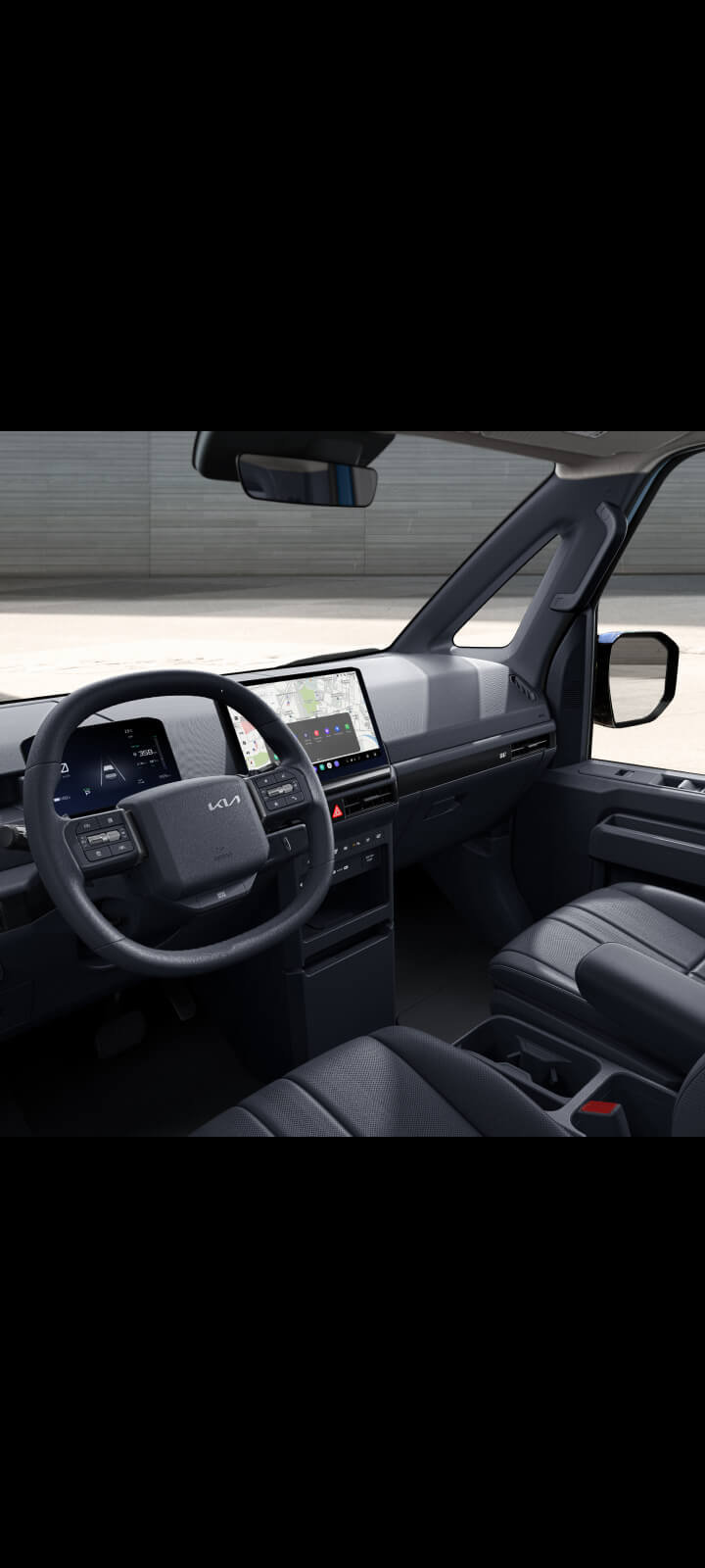 Driver holding steering wheel of the Kia PV5 Passenger with navigation screen visible